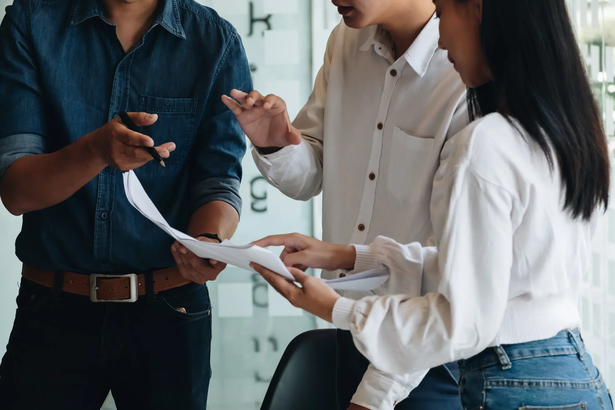 Startup team reviewing employment contract documents in a collaborative office setting.