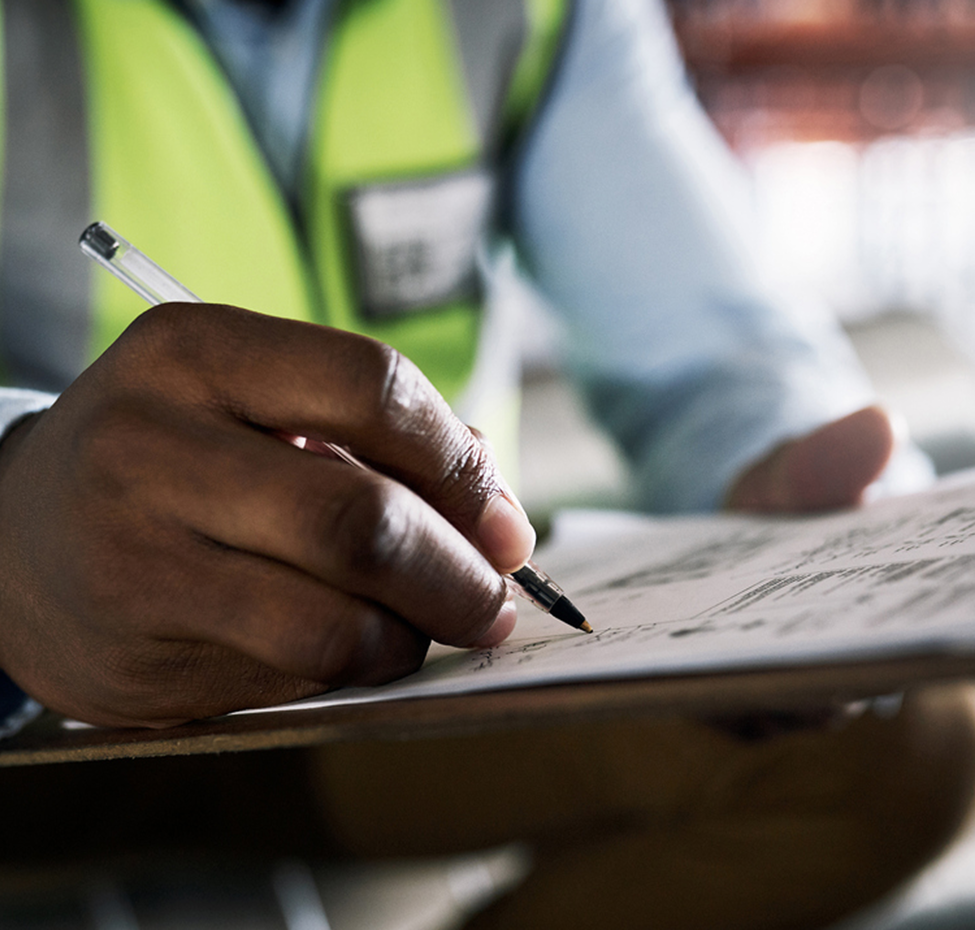 A close up image of a contractor at the  construction attorney office signing documents